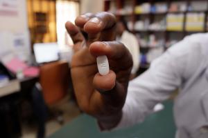 A doctor holds a tablet with a M imprint